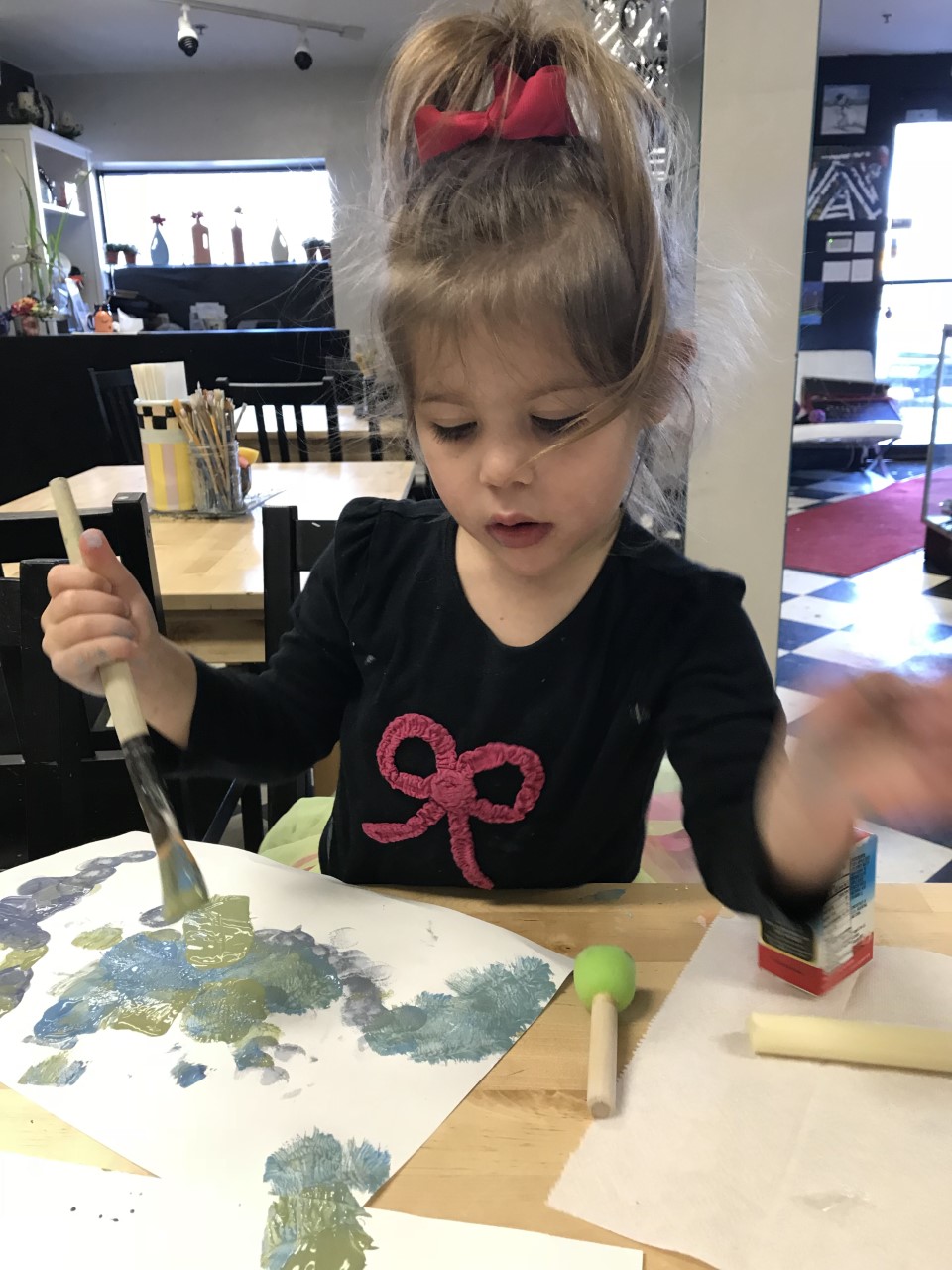 Children enjoying a pottery party, molding clay and painting ceramics in Englewood, NJ