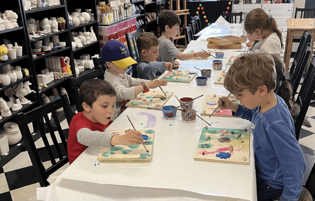Kids having a blast at a Glow Party creating vibrant canvas painting art in Englewood, NJ